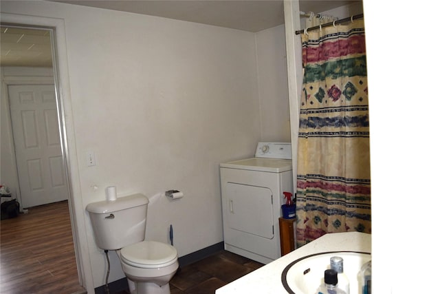 bathroom with vanity, washer / dryer, hardwood / wood-style floors, and toilet