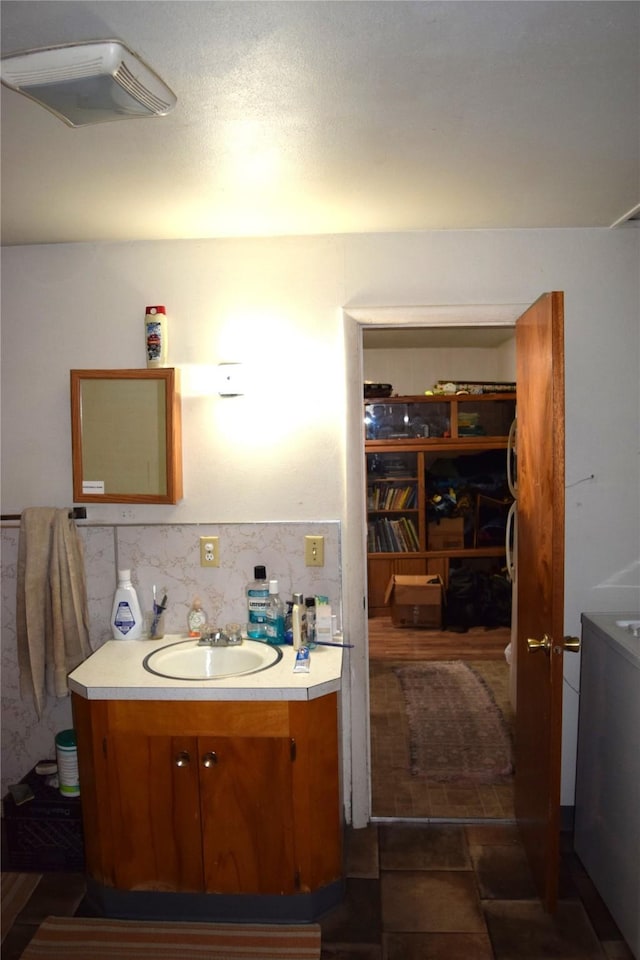 bathroom with vanity and backsplash