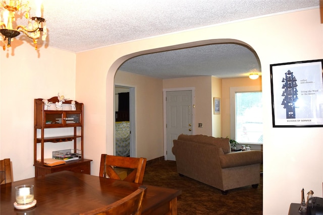 carpeted dining area featuring a textured ceiling