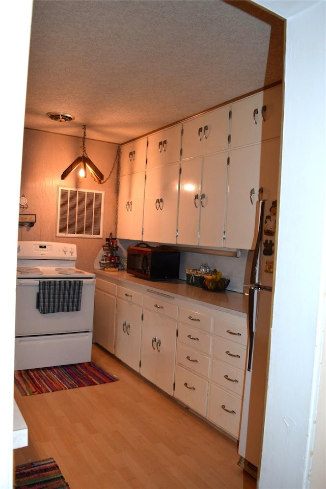 kitchen featuring white electric range, white cabinets, fridge, a textured ceiling, and light hardwood / wood-style flooring