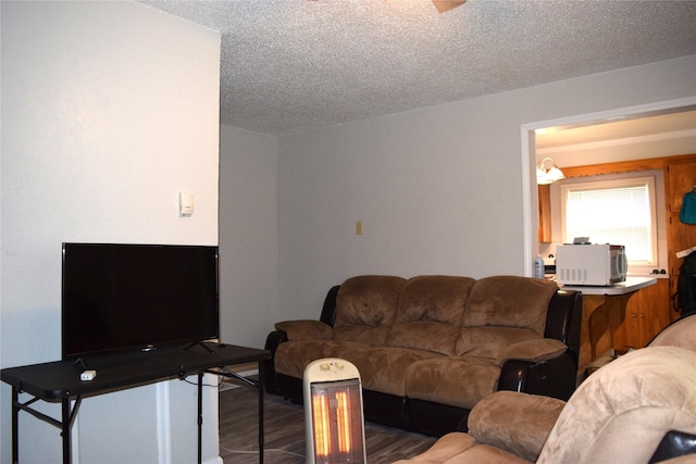 living area with a textured ceiling and wood finished floors
