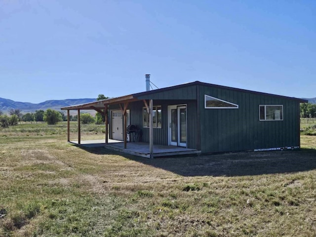 exterior space featuring a mountain view and a front yard