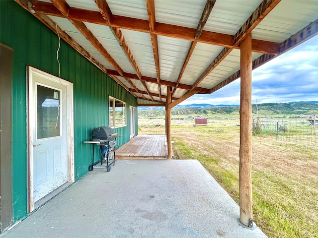 view of patio / terrace featuring a grill, a mountain view, and a rural view