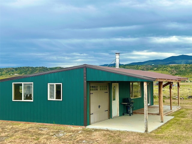 view of outbuilding featuring a mountain view and a garage