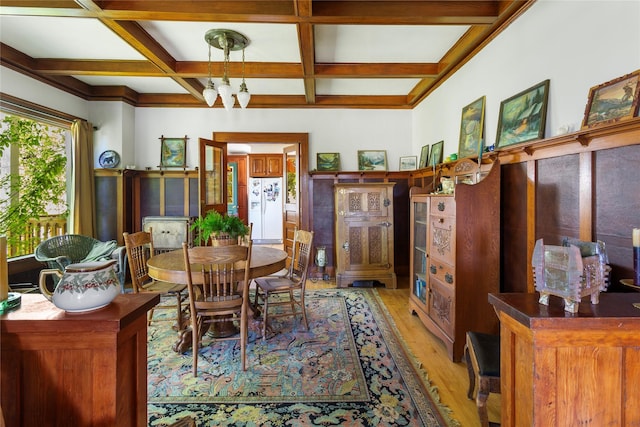 dining area featuring beamed ceiling, a chandelier, coffered ceiling, and light hardwood / wood-style floors