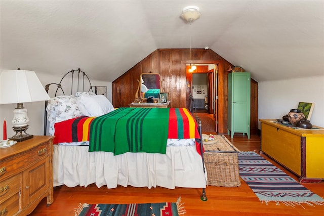 bedroom featuring dark wood-type flooring and vaulted ceiling