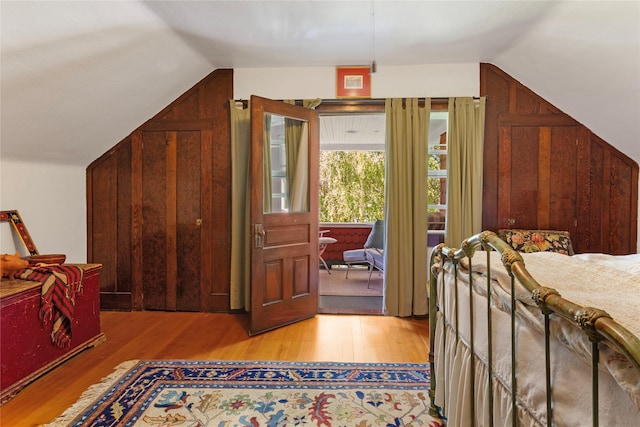 bedroom featuring light wood-type flooring and lofted ceiling