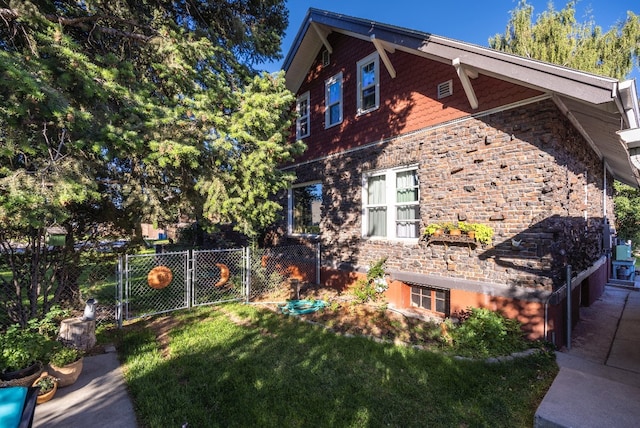 view of side of property with a lawn