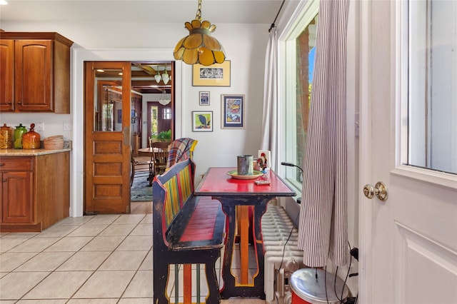 dining space featuring light tile patterned flooring