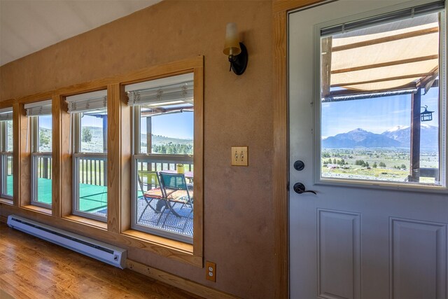 3851 Reed Butte Rd, Stevensville, MT 59870 - doorway to outside with a baseboard radiator, a mountain view, and wood finished floors