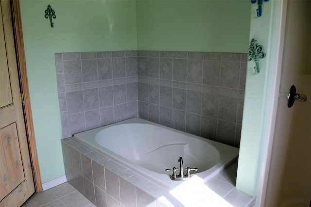 bathroom featuring tile patterned flooring and tiled bath