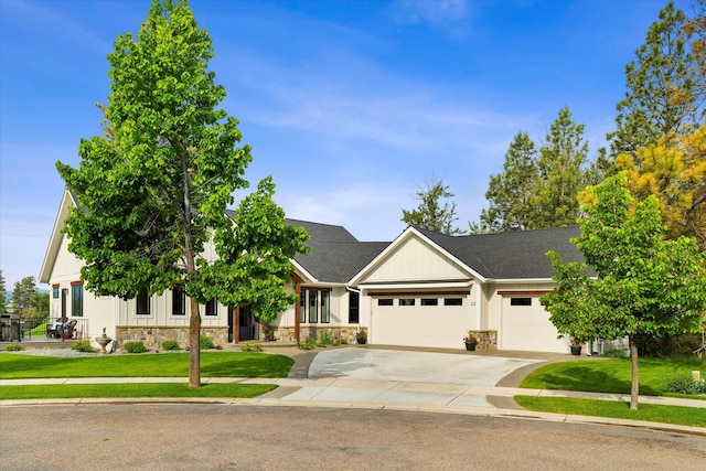 view of front of house with a garage and a front lawn