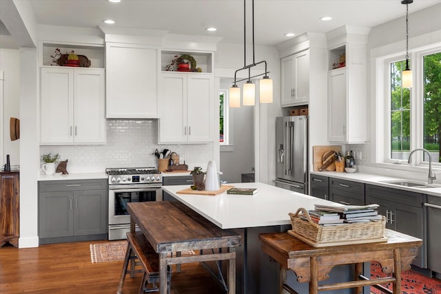 kitchen featuring gray cabinets, pendant lighting, and stainless steel appliances