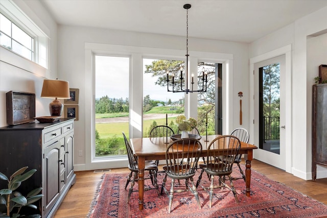 dining space featuring a chandelier and light hardwood / wood-style floors