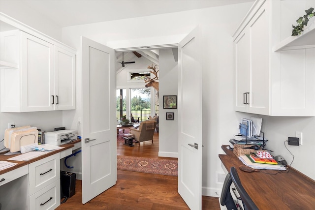 office area featuring dark hardwood / wood-style flooring, built in desk, and ceiling fan