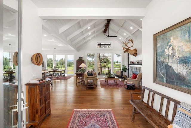 interior space with beamed ceiling, high vaulted ceiling, dark hardwood / wood-style floors, and ceiling fan