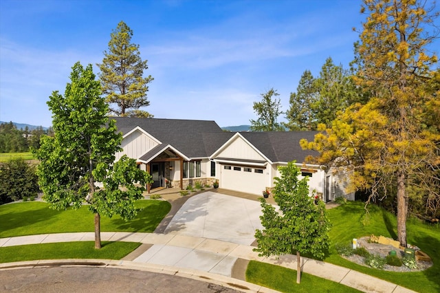 view of front of property with a garage and a front lawn