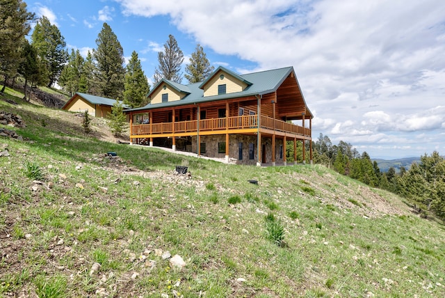 rear view of property featuring a wooden deck