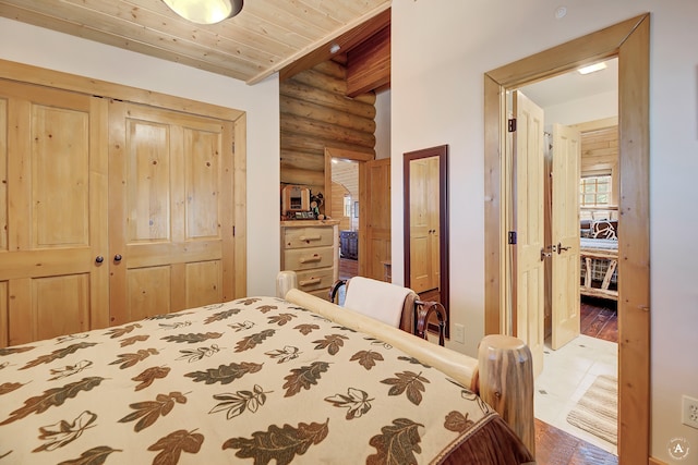 bedroom featuring rustic walls, a closet, and hardwood / wood-style flooring