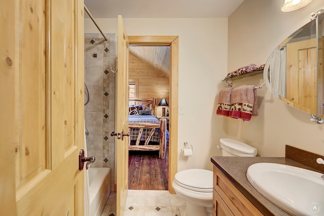 bathroom featuring tile flooring, wooden walls, vanity, and toilet