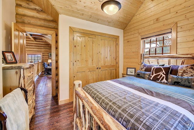 bedroom featuring log walls, lofted ceiling, a closet, and dark wood-type flooring