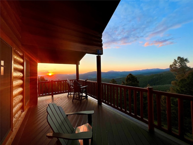 deck at dusk featuring a mountain view