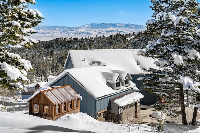 snowy aerial view with a mountain view