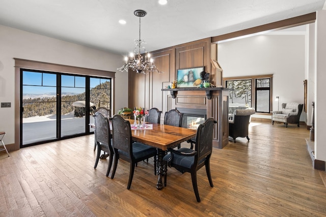 dining area with dark hardwood / wood-style flooring and a chandelier