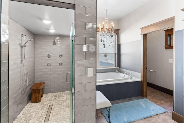 bathroom with an inviting chandelier, a shower stall, baseboards, and a bath