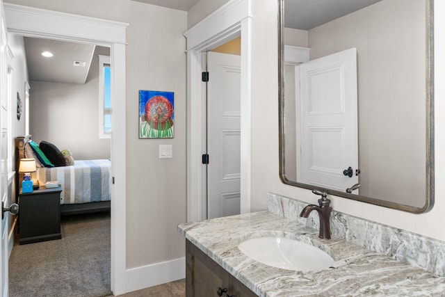 bathroom featuring recessed lighting, visible vents, connected bathroom, vanity, and baseboards