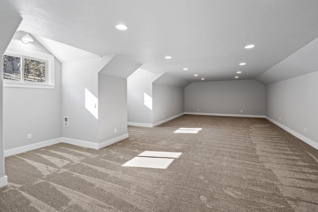 additional living space featuring lofted ceiling, recessed lighting, visible vents, carpet flooring, and baseboards