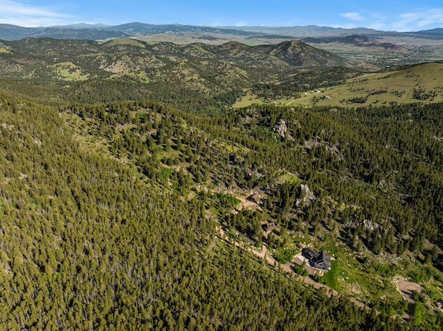 bird's eye view featuring a mountain view and a wooded view