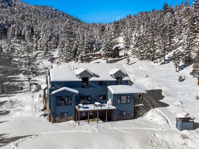 snowy aerial view with a mountain view