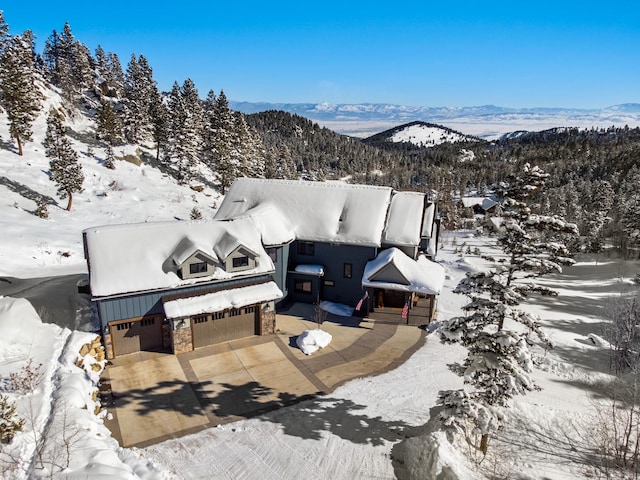 snowy aerial view with a mountain view