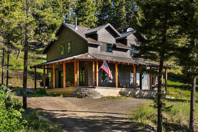 view of front of house featuring a standing seam roof, covered porch, and metal roof