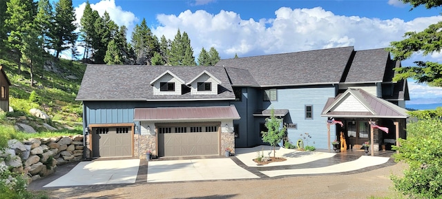 view of front of property featuring concrete driveway, board and batten siding, and stone siding