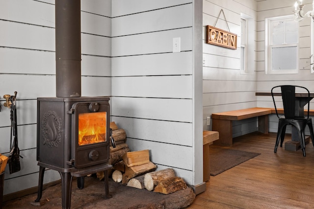 interior details with wood finished floors and a wood stove