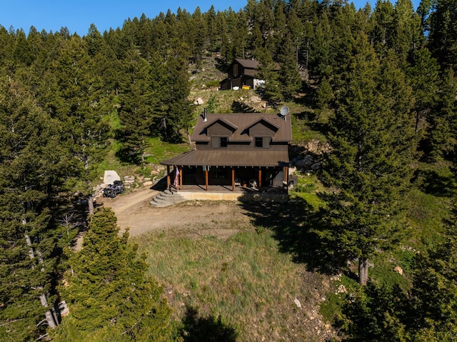 birds eye view of property with a forest view