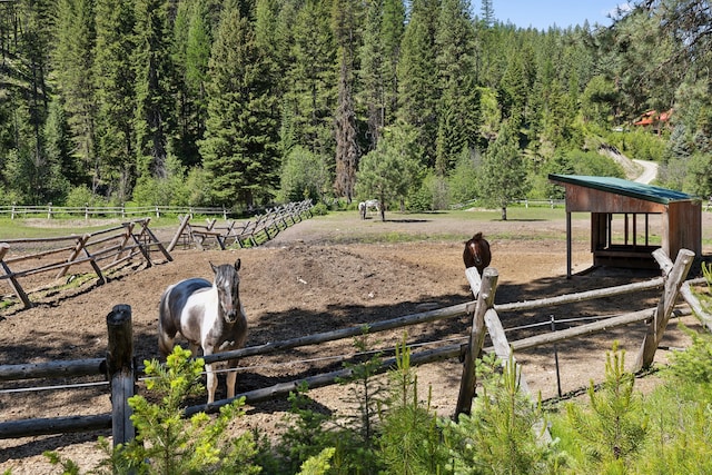 view of horse barn with a rural view