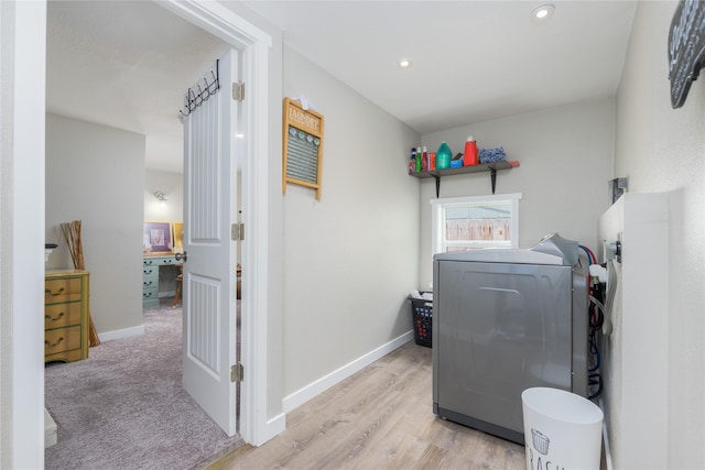 washroom with washer / dryer and light carpet