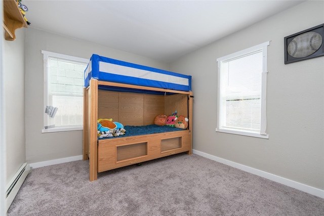 carpeted bedroom featuring baseboard heating