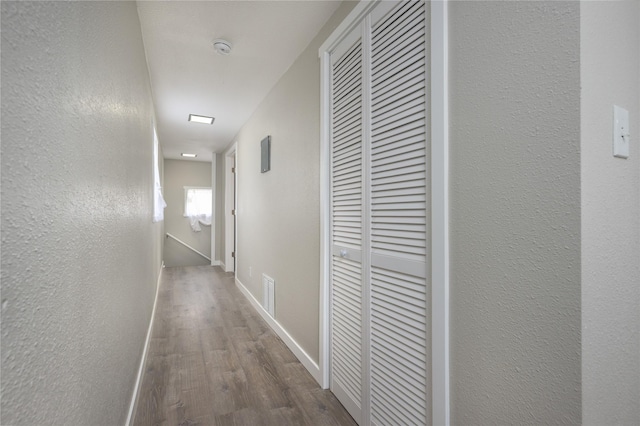 hallway with dark wood-type flooring