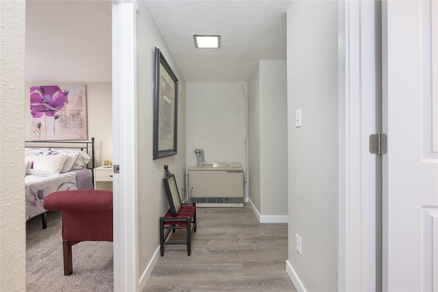 corridor with light hardwood / wood-style floors