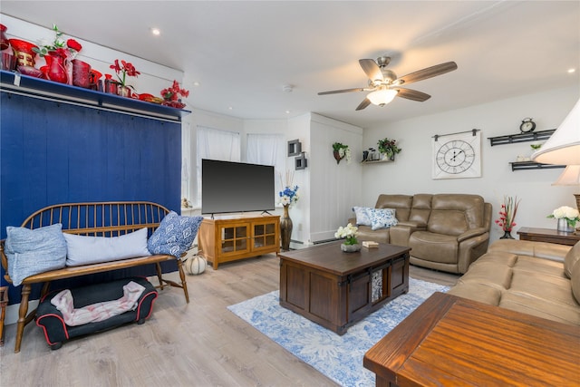 living room featuring ceiling fan and light hardwood / wood-style flooring