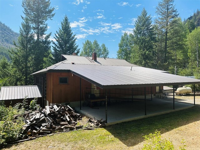 8 Cedar Gulch Ln, Thompson Falls, MT 59873 - view of side of property with a metal roof and a carport