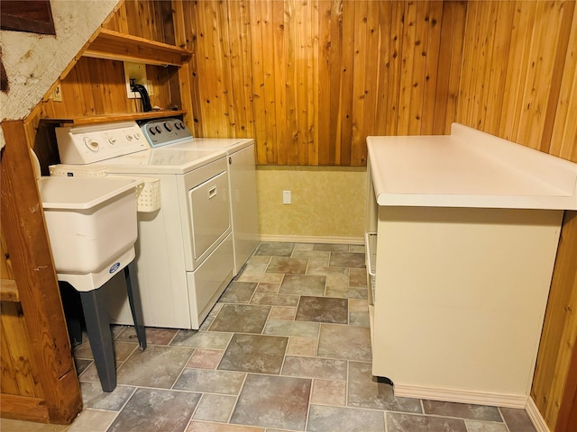 8 Cedar Gulch Ln, Thompson Falls, MT 59873 - washroom featuring separate washer and dryer, wooden walls, and stone finish flooring