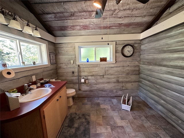 bathroom featuring vanity, lofted ceiling, wooden walls, and wooden ceiling