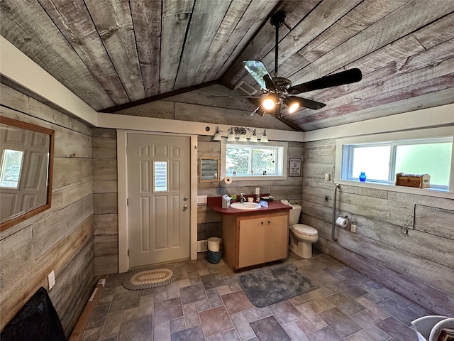 bathroom featuring vaulted ceiling, a wealth of natural light, wooden walls, and wood ceiling