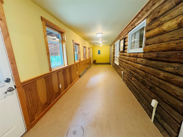 8 Cedar Gulch Ln, Thompson Falls, MT 59873 - hall featuring log walls, wainscoting, a baseboard heating unit, and light carpet