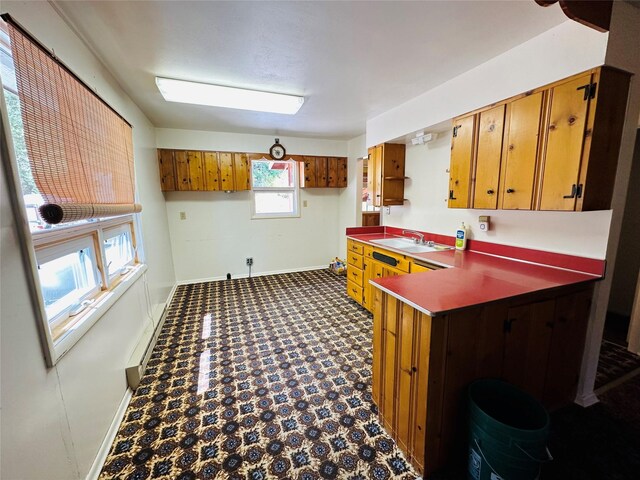 8 Cedar Gulch Ln, Thompson Falls, MT 59873 - kitchen with brown cabinets, dark countertops, a peninsula, and dark floors